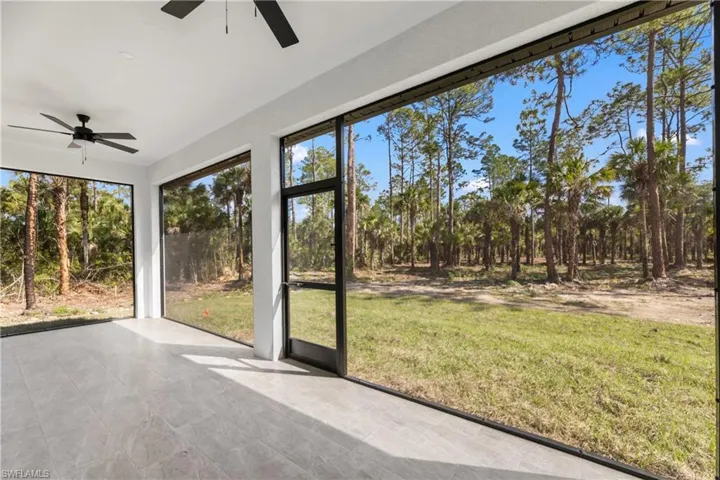 Unfurnished sunroom with ceiling fan