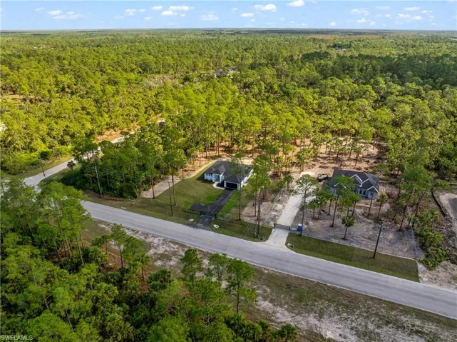Drone / aerial view featuring a wooded view