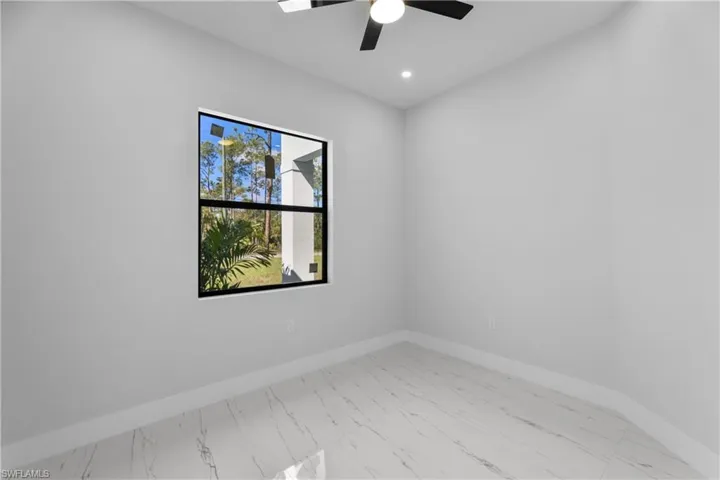 Spare room with marble finish floor, recessed lighting, and baseboards