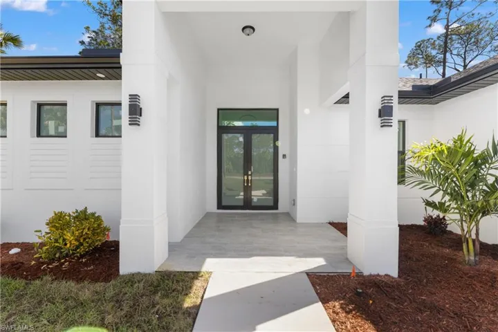 Doorway to property with french doors and stucco siding