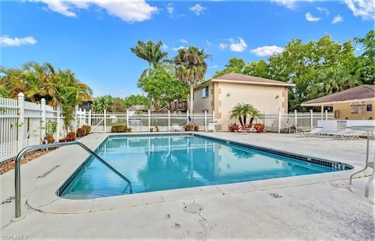 Community pool with fence and a patio