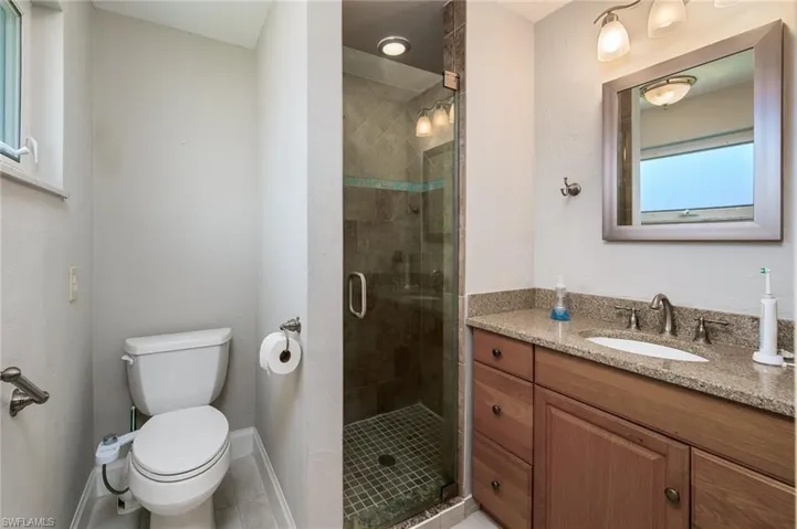 Updated owners bath with tiled shower, floor & granite.