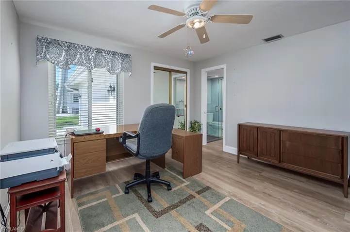 Guest bedroom /Home office with closet, ceiling fan & bath with pocket door.