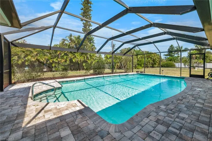 View of back yard from the screened in pool.