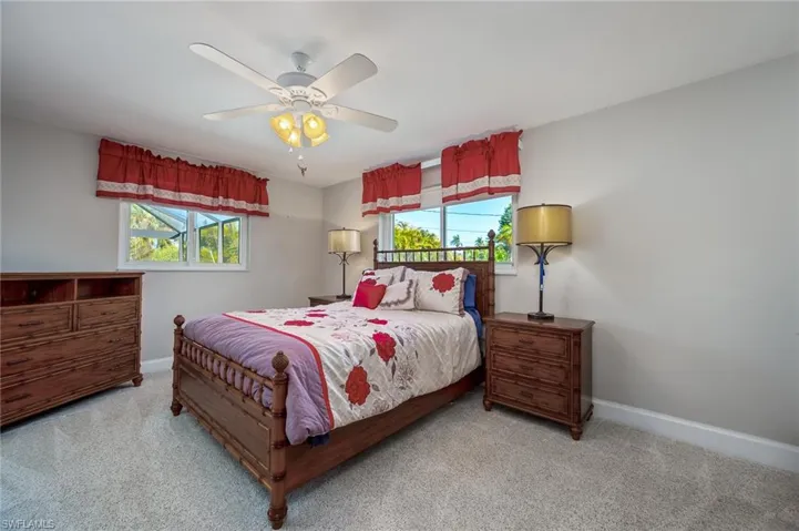 Owners Bedroom with sliders to the pool, walk in closet, carpet and owners' bath.