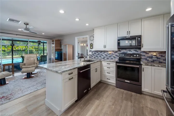 Kitchen adjoins to the family room with access to the lanai and pool area.