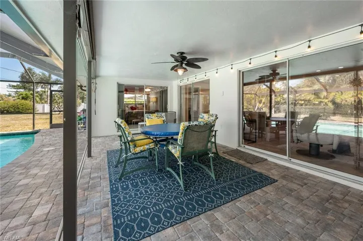Large covered lanai with sliders to the owners bedroom, dining room & family room.