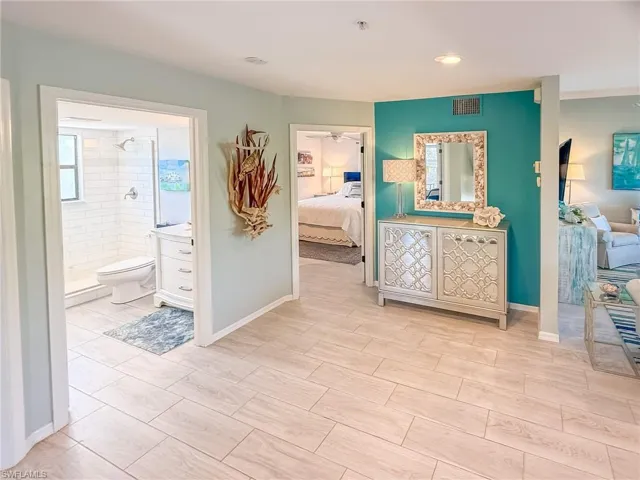 Hall featuring visible vents and baseboards