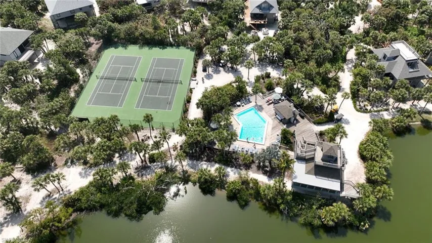 Birds eye view of property with a water view
