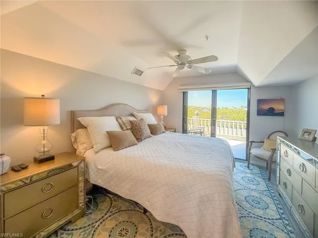 Bedroom with access to exterior, visible vents, ceiling fan, light colored carpet, and lofted ceiling