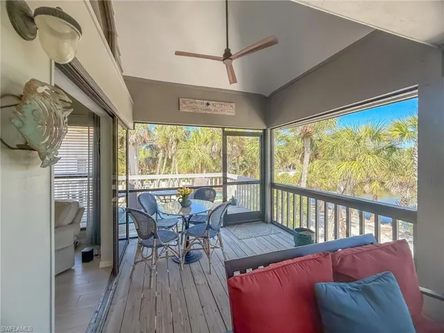 Sunroom / solarium with lofted ceiling and a ceiling fan
