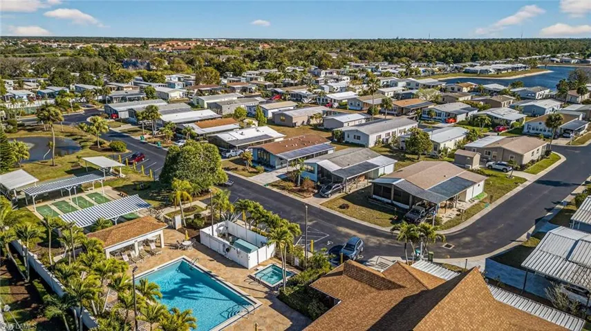 Aerial perspective of suburban area featuring a pool