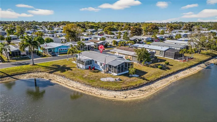 Aerial perspective of suburban area featuring a nearby body of water