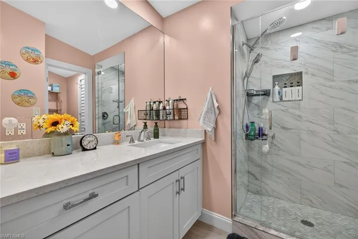 Bathroom with vanity and a shower stall
