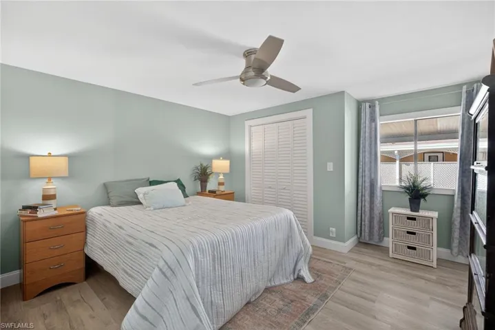 Bedroom featuring a closet, ceiling fan, and light wood-style flooring