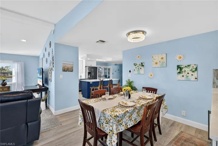Dining area featuring light wood-type flooring and baseboards