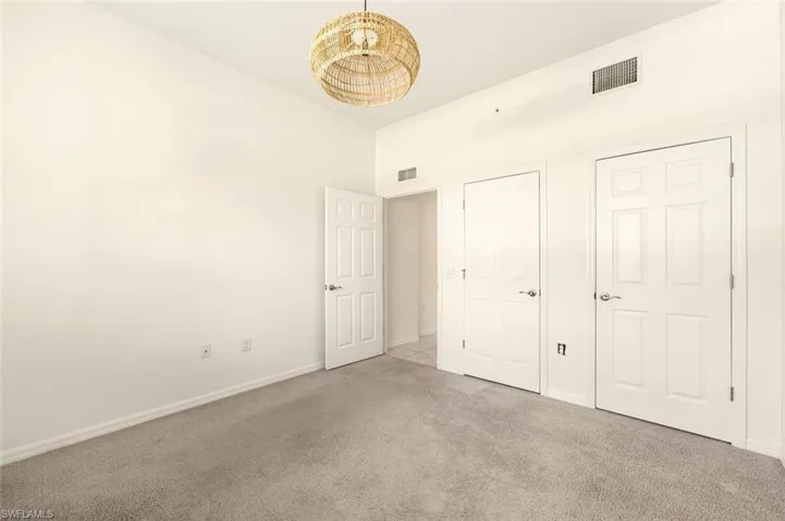 Unfurnished bedroom featuring carpet flooring and baseboards