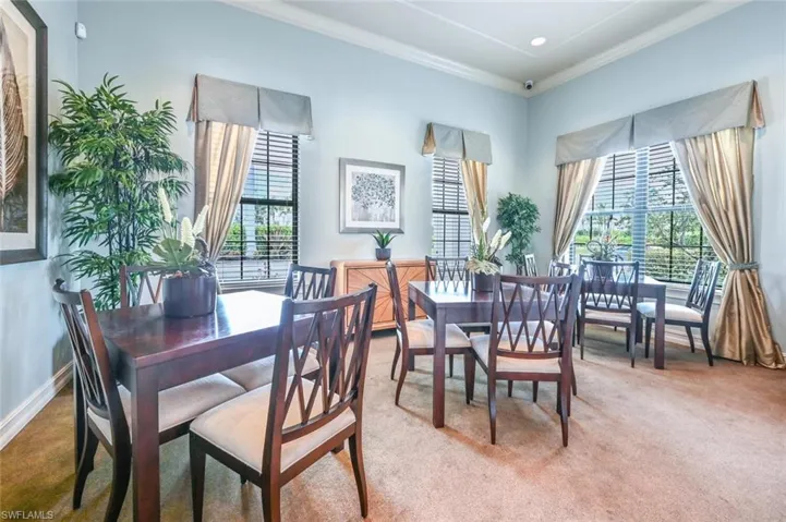 Dining space featuring crown molding and carpet flooring