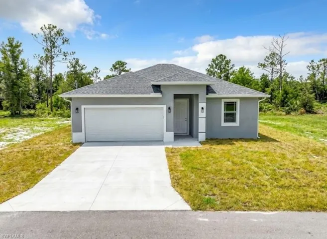 View of front of home featuring a front lawn, stucco siding, concrete driveway, an attached garage, and roof with shingles
