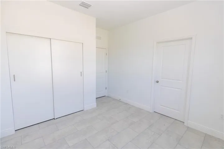 Unfurnished bedroom with baseboards and a closet