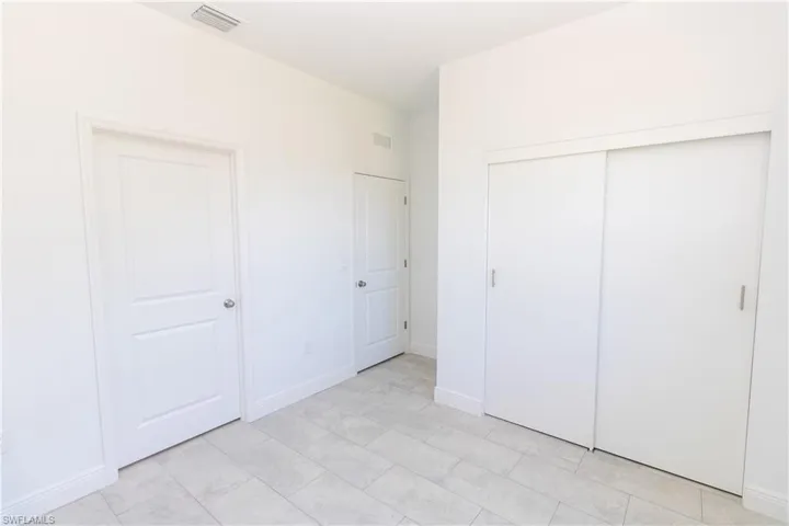 Unfurnished bedroom with baseboards and a closet