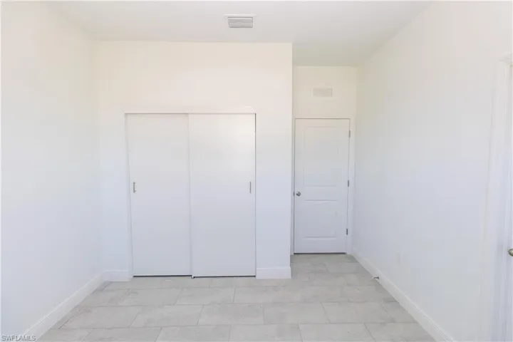Unfurnished bedroom featuring baseboards and a closet