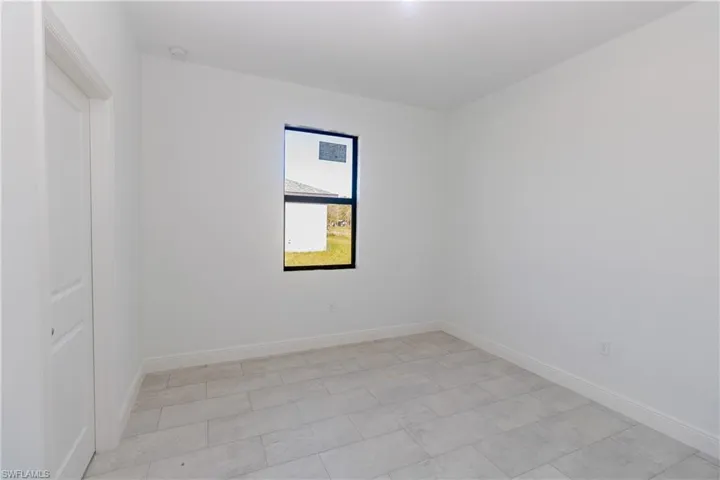 Spare room featuring baseboards