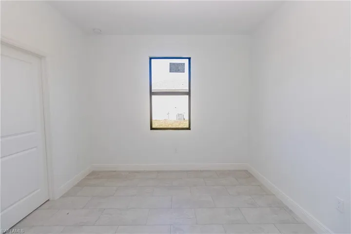 Empty room featuring baseboards