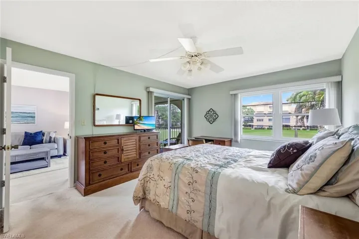 Primary bedroom with golf course views and lanai entry.