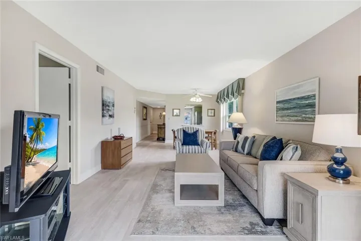 Living and dining area.  Primary bedroom door to the left.
