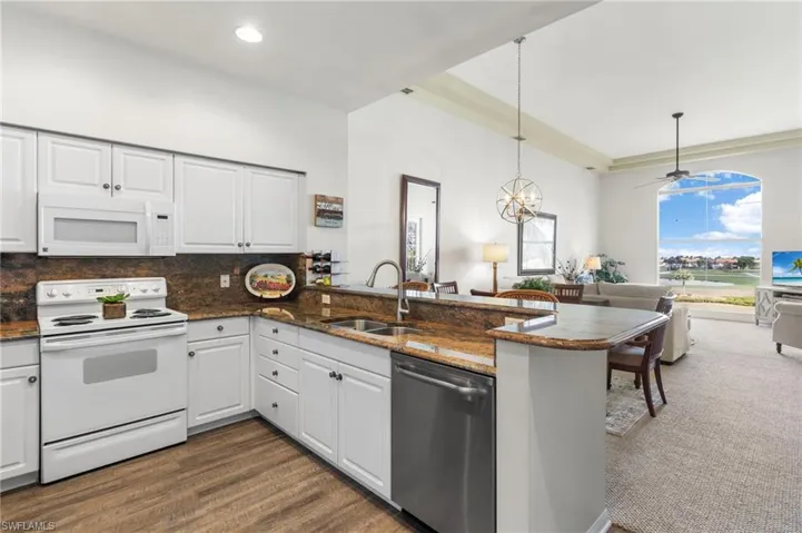 The kitchen showcases rich granite countertops that combine style and durability.