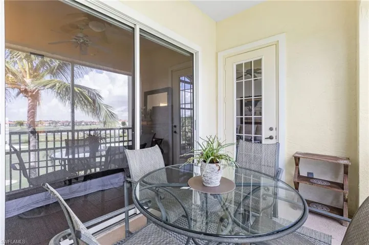 Both the main living area and the primary suite provide direct access to the lanai, offering uninterrupted views of the lake and golf course.