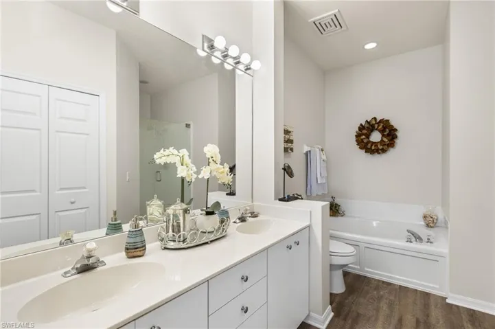 Your primary suite offers a spa-like ensuite with a soaking tub, separate walk-in shower with seamless glass enclosure, and a walk-in closet to keep everything organized.