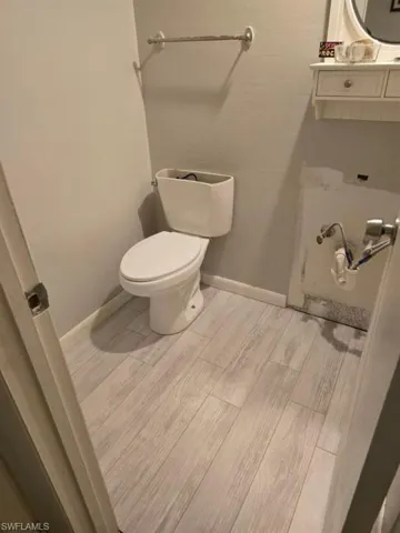 Bathroom featuring hardwood / wood-style flooring and toilet