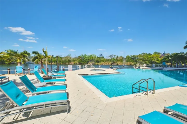 Community pool featuring a hot tub and a patio area