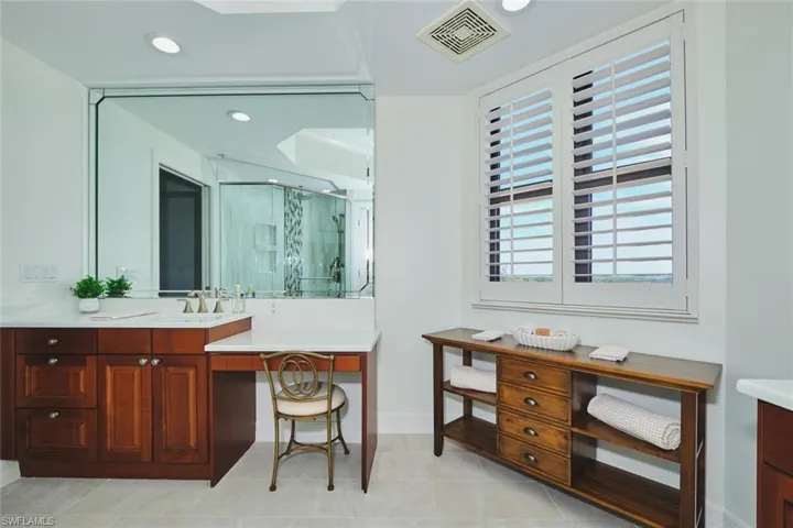 Bathroom featuring visible vents, a stall shower, vanity, baseboards, and recessed lighting