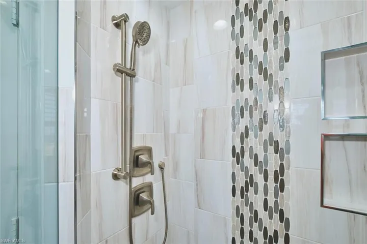 Full bath featuring a tile shower