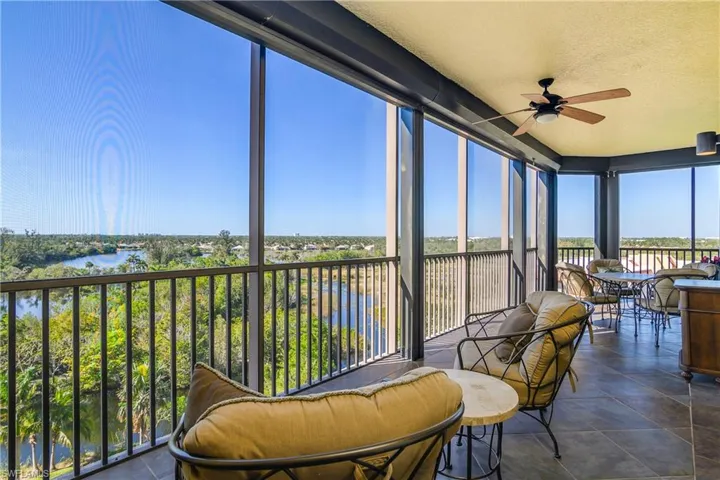 Sunroom with a water view and ceiling fan
