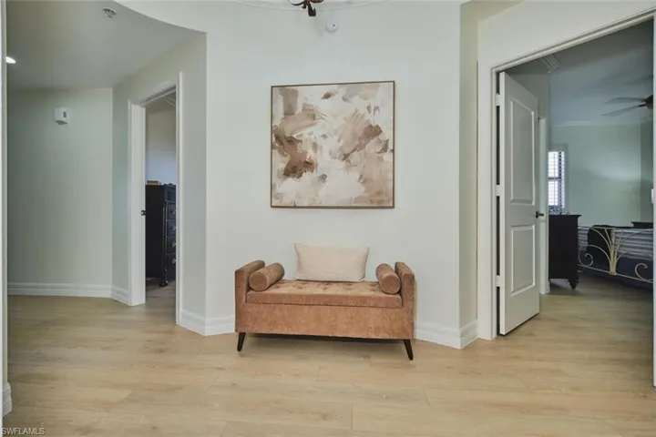 Sitting room featuring light wood-style floors, baseboards, and ceiling fan