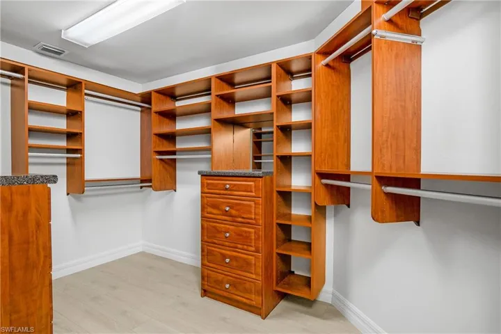 Spacious closet featuring light wood-type flooring