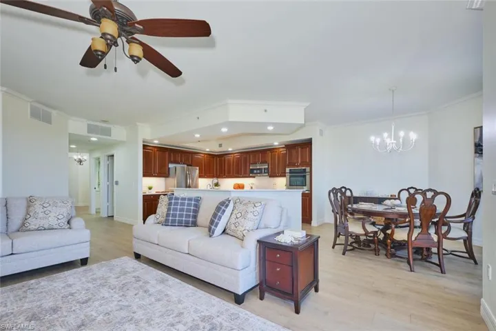 Living area featuring visible vents, ornamental molding, baseboards, recessed lighting, and light wood finished floors