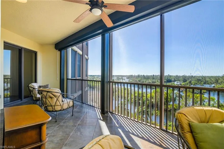 Sunroom featuring ceiling fan, a water view, and a wealth of natural light