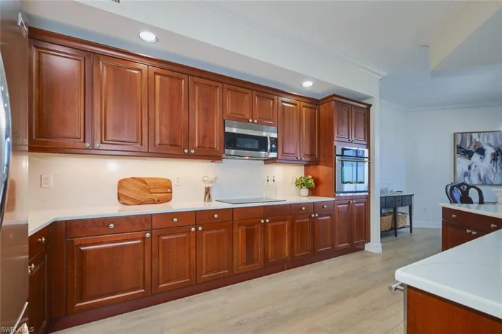 Kitchen with light wood-style floors, recessed lighting, backsplash, and stainless steel appliances