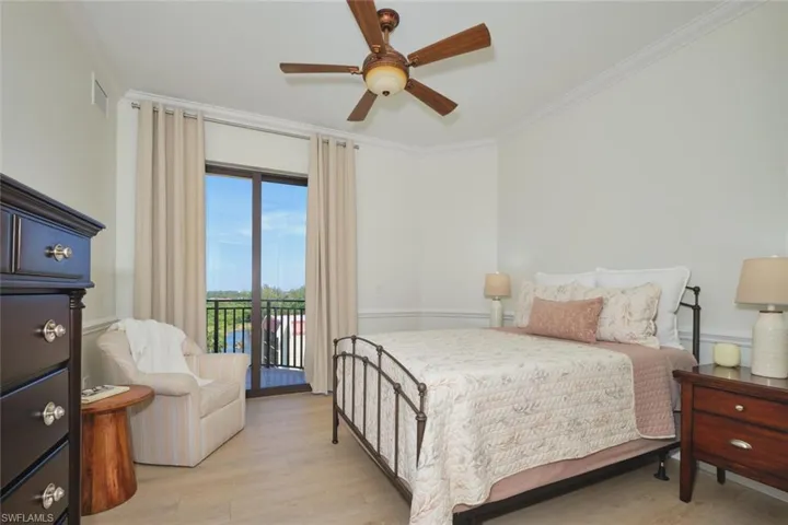 Bedroom with ceiling fan, visible vents, crown molding, access to exterior, and light wood-type flooring