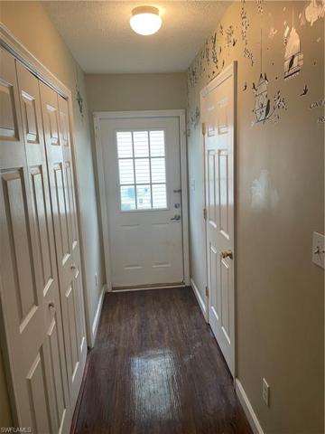 Side house entry hallway /left laundry/right half bath