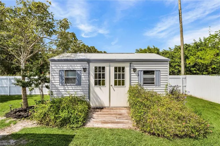 View of outbuilding with a fenced backyard