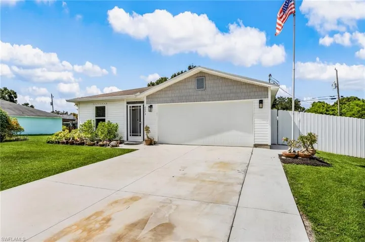 Ranch-style house featuring driveway and an attached garage