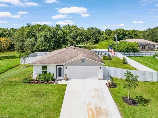 Single story home with driveway and an attached garage