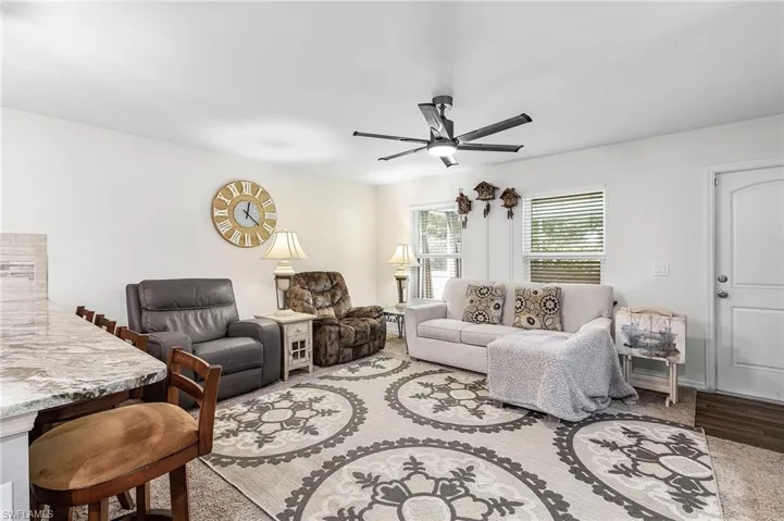 Living area featuring ceiling fan and wood finished floors
