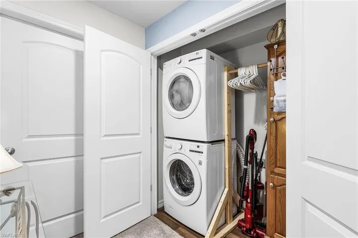 Washroom with stacked washer / drying machine